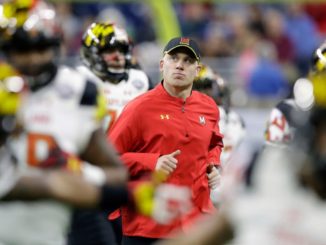 Maryland head coach DJ Durkin runs onto the field before the Quick Lane Bowl NCAA college football game against Boston College in Detroit.